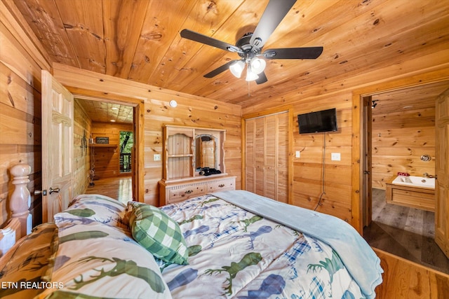 bedroom featuring wood walls, wood ceiling, wood finished floors, a closet, and a ceiling fan