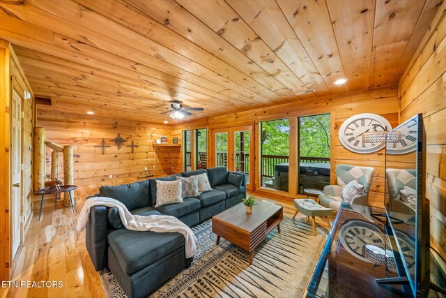living area with wood ceiling, wood finished floors, wooden walls, recessed lighting, and french doors