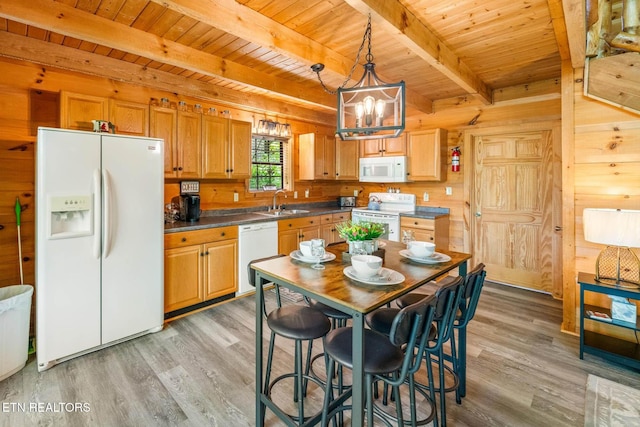 kitchen featuring white appliances, light wood-style floors, wooden walls, wooden ceiling, and dark countertops