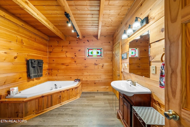 bathroom with wooden ceiling, track lighting, wood finished floors, a bath, and vanity