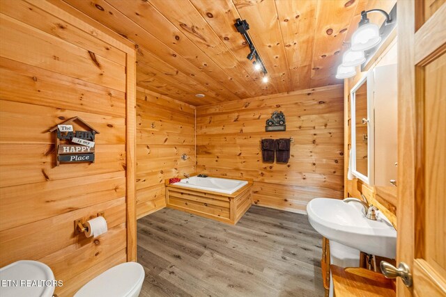 bathroom featuring toilet, rail lighting, wood finished floors, wooden ceiling, and wooden walls