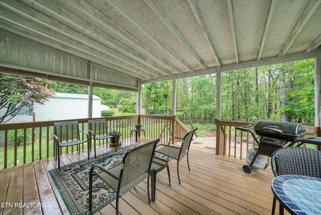 wooden deck featuring outdoor dining space and area for grilling