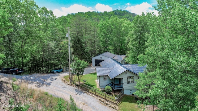 aerial view of property and surrounding area with a forest