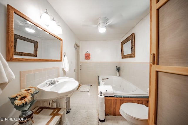 bathroom featuring a bath, tile patterned floors, and toilet