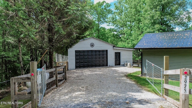 detached garage featuring fence