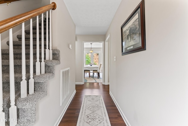 9945 Tierra Verde Dr, Knoxville, TN 37922 - hallway featuring stairway, dark wood-type flooring, and baseboards