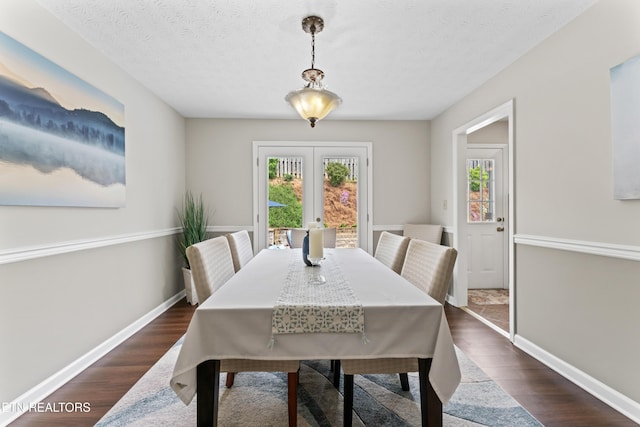 9945 Tierra Verde Dr, Knoxville, TN 37922 - dining area featuring dark wood-style flooring, baseboards, french doors, and a textured ceiling