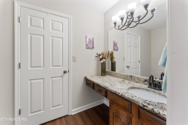 9945 Tierra Verde Dr, Knoxville, TN 37922 - bathroom featuring wood finished floors, a chandelier, baseboards, and vanity