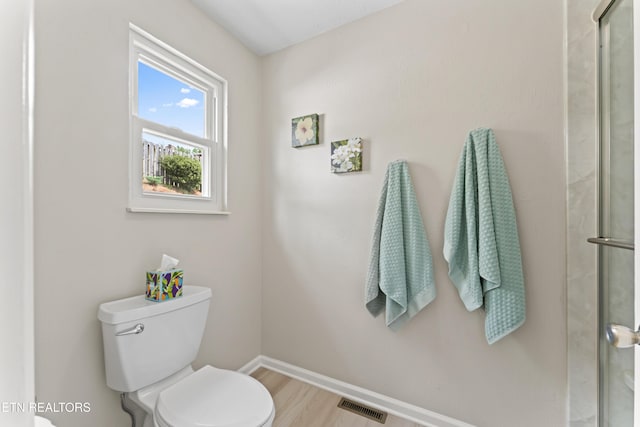 9945 Tierra Verde Dr, Knoxville, TN 37922 - bathroom featuring toilet, baseboards, wood finished floors, and a shower with shower door
