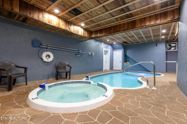 view of pool with a pool with connected hot tub