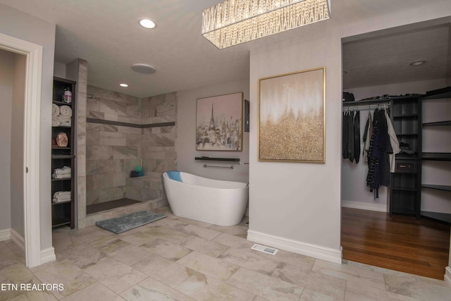409 Celebration Rd, Knoxville, TN 37934 - full bath with walk in shower, a freestanding tub, baseboards, recessed lighting, and a spacious closet