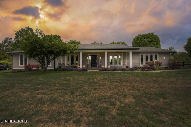 409 Celebration Rd, Knoxville, TN 37934 - back of house at dusk featuring a lawn