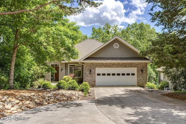 401 Shawnee Pl, Loudon, TN 37774 - view of front of home with driveway, an attached garage, brick siding, and roof with shingles