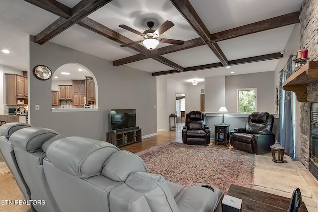401 Shawnee Pl, Loudon, TN 37774 - living area featuring coffered ceiling, beamed ceiling, a ceiling fan, light wood-style flooring, and a stone fireplace