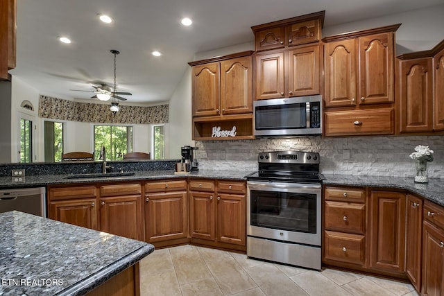 401 Shawnee Pl, Loudon, TN 37774 - kitchen with stainless steel appliances, a sink, light tile patterned floors, a ceiling fan, and backsplash