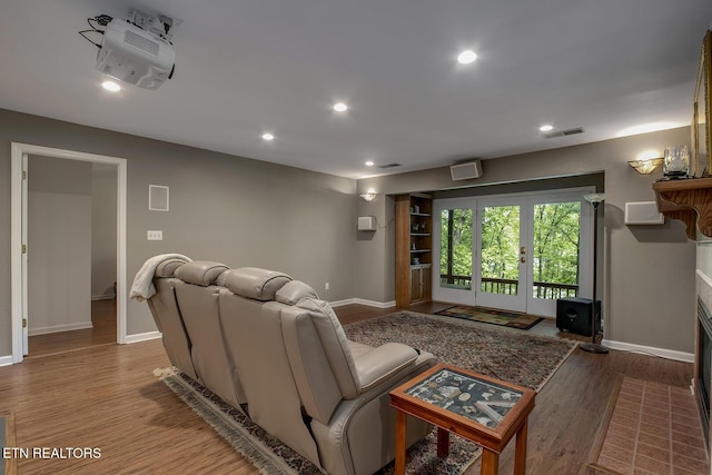 401 Shawnee Pl, Loudon, TN 37774 - living room with baseboards, wood finished floors, recessed lighting, a fireplace with flush hearth, and french doors