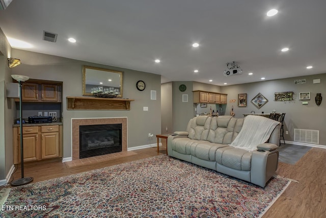 401 Shawnee Pl, Loudon, TN 37774 - living area with wood finished floors, baseboards, a tile fireplace, and recessed lighting
