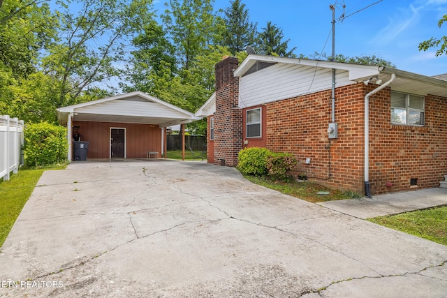 513 Long Mill Rd, Athens, TN 37303 - view of side of home with driveway, a chimney, a carport, and brick siding