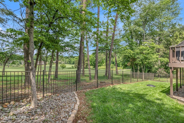view of yard with view of golf course and view of scattered trees