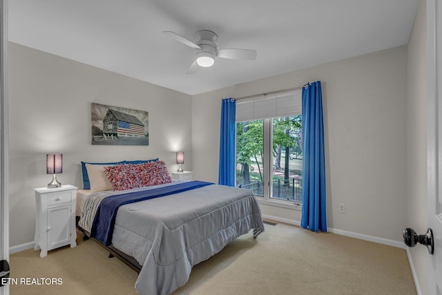 bedroom featuring light carpet, baseboards, and a ceiling fan