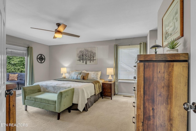 bedroom with light colored carpet, a ceiling fan, baseboards, and access to outside