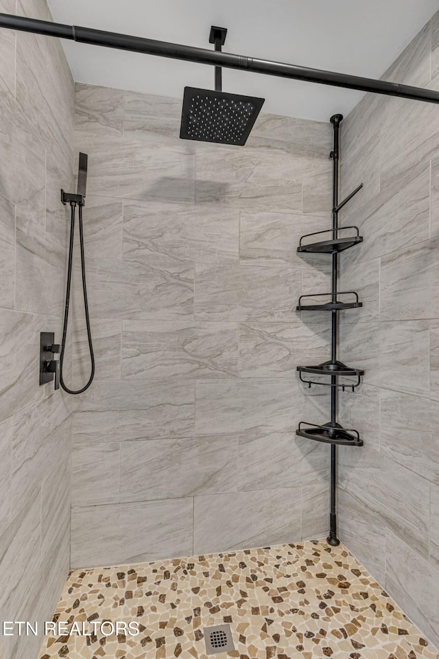 bathroom with a tile shower