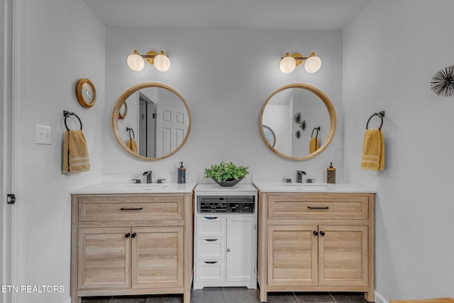 bathroom with two vanities, tile patterned floors, and baseboards