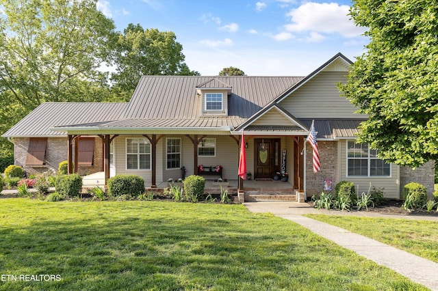 3083 Waters Edge Dr, Morristown, TN 37814 - view of front facade featuring covered porch, a front yard, metal roof, and brick siding