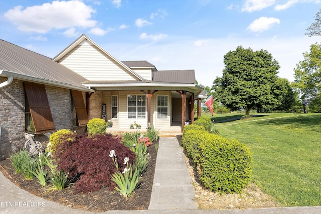 3083 Waters Edge Dr, Morristown, TN 37814 - view of front facade featuring metal roof, a front yard, covered porch, and brick siding