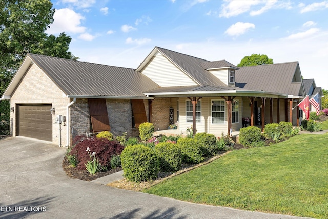 3083 Waters Edge Dr, Morristown, TN 37814 - view of front facade with a garage, metal roof, a front yard, driveway, and brick siding