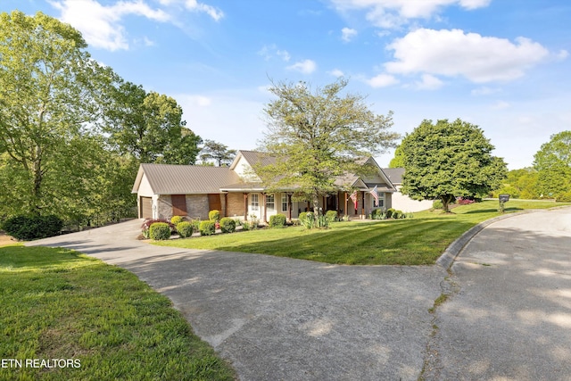 3083 Waters Edge Dr, Morristown, TN 37814 - view of front of property featuring driveway, a front lawn, metal roof, an attached garage, and covered porch