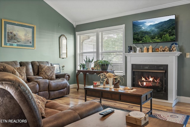 3083 Waters Edge Dr, Morristown, TN 37814 - living room with wood finished floors, lofted ceiling, ornamental molding, a lit fireplace, and baseboards
