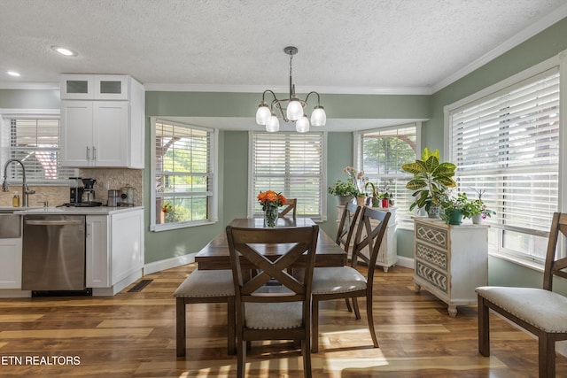 3083 Waters Edge Dr, Morristown, TN 37814 - dining area featuring crown molding, dark wood finished floors, plenty of natural light, a chandelier, and a textured ceiling
