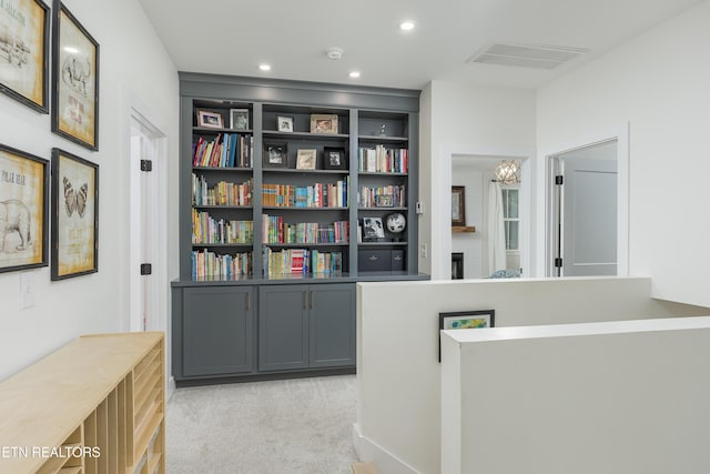 819 NW Morgan Rd, Charleston, TN 37310 - hallway with light carpet, built in shelves, a chandelier, and recessed lighting