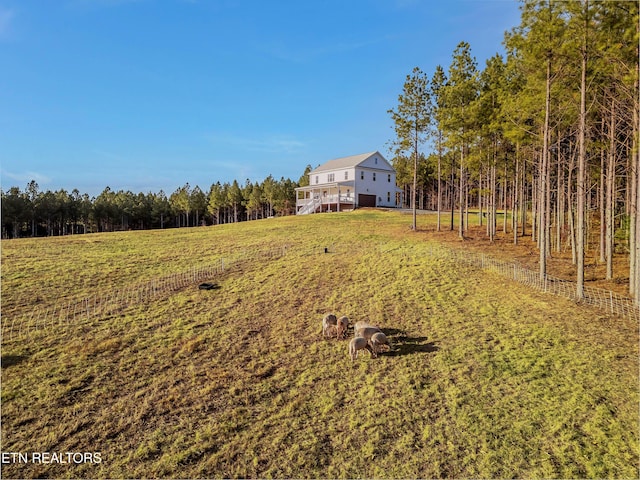 819 NW Morgan Rd, Charleston, TN 37310 - view of grassy yard with stairway and a wooded view
