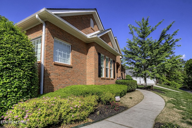 view of side of property with brick siding