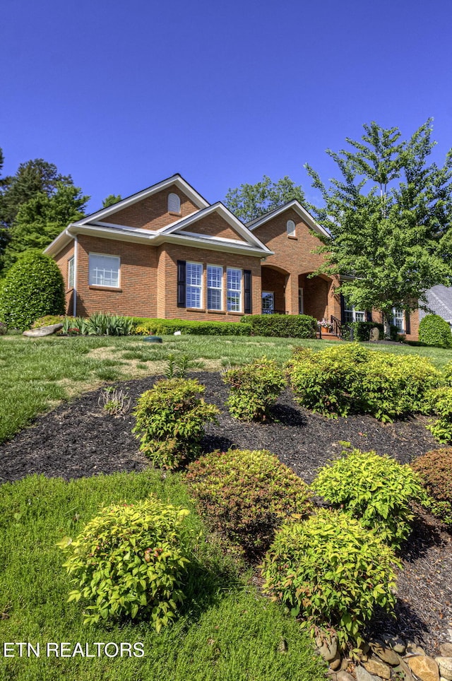 view of front of house featuring brick siding