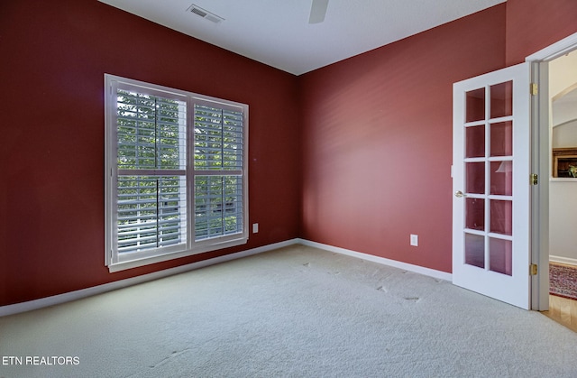 empty room featuring carpet floors, ceiling fan, and baseboards