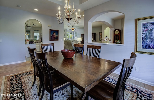 dining room featuring wood finished floors, ceiling fan, a chandelier, baseboards, and recessed lighting