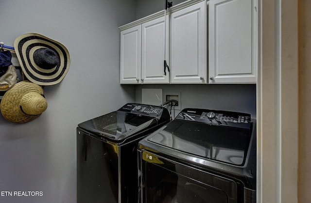 laundry area with independent washer and dryer and cabinet space