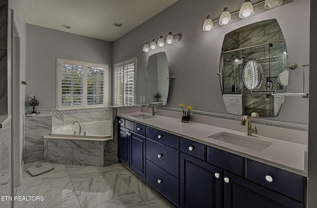 bathroom featuring marble look tiles, a bath, a shower stall, and double vanity