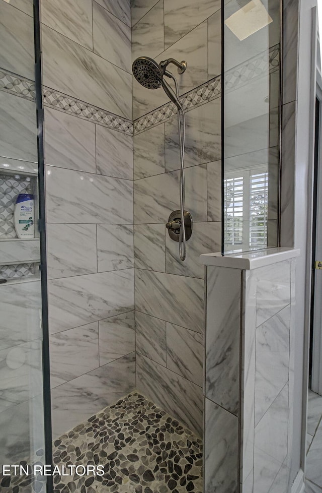 bathroom with tiled shower