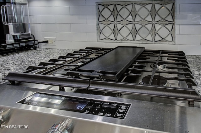kitchen view of decorative backsplash and range