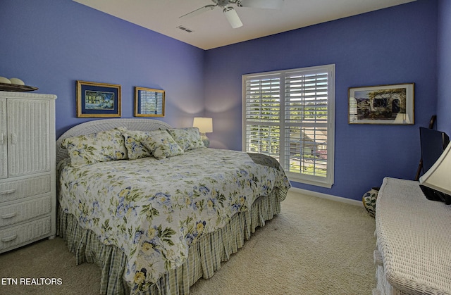 carpeted bedroom with baseboards and a ceiling fan