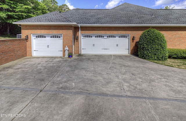 garage with concrete driveway