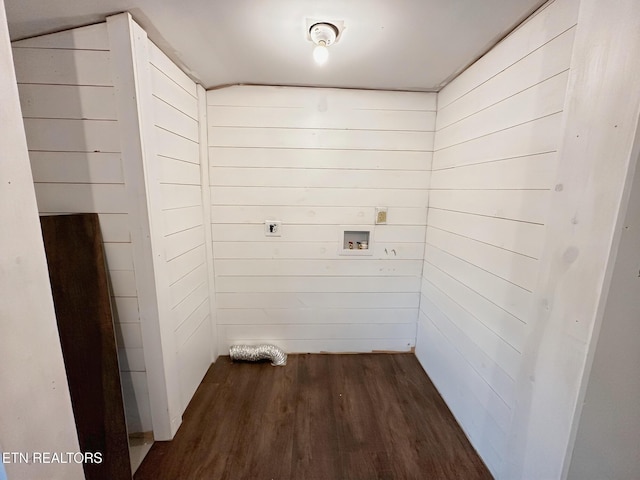 laundry area featuring electric dryer hookup, dark wood-style flooring, wooden walls, and washer hookup