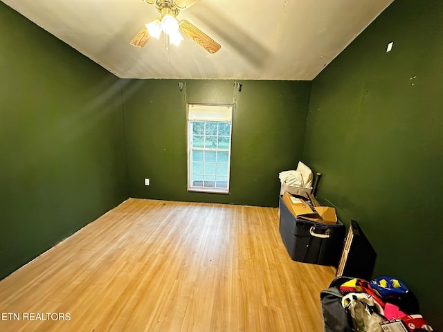 additional living space with wood finished floors and a ceiling fan