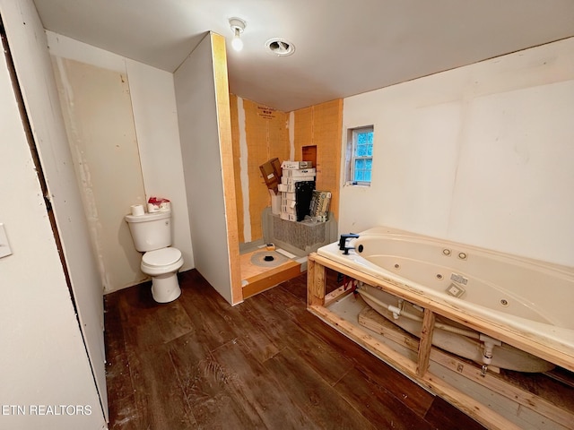 full bath featuring wood finished floors, toilet, a stall shower, and a tub with jets