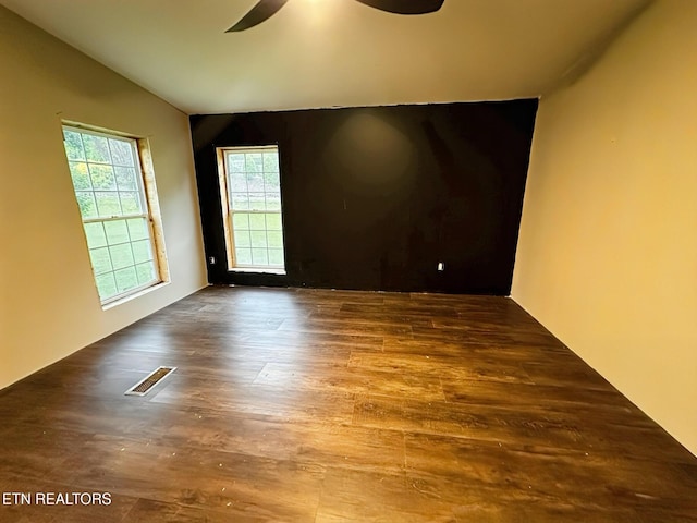 spare room featuring ceiling fan, wood finished floors, and lofted ceiling