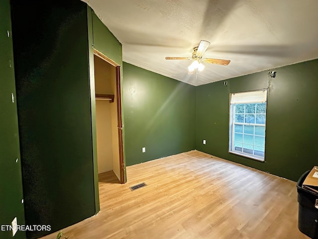 unfurnished bedroom featuring light wood finished floors and a ceiling fan